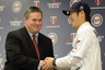 MINNEAPOLIS MN: Tsuyoshi Nishioka #1 of the Minnesota Twins shakes hands with general manager Bill Smith (L) during a press conference on  at Target Field in Minneapolis Minnesota. (Photo by Hannah Foslien/Getty Images)