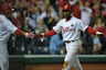 PHILADELPHIA, PA:  Jimmy Rollins #11 and Shane Victorino #8 of the Philadelphia Phillies celebrate after Rollins scored on a Ryan Howard #6 RBI single in the first inning against the St. Louis Cardinals in Game Two of the National League Division Series at Citizens Bank Park on in Philadelphia, Pennsylvania.  (Photo by Drew Hallowell/Getty Images)