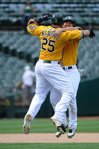 OAKLAND, CA - APRIL 25:  Kila Ka'aihue #25 and Kurt Suzuki #8 of the Oakland Athletics celebrates after Ka'aihue hit a walk off rbi single driving in Seth Smith #15 in the bottom of the fourteenth inning to defeat the Chicago White Sox 5-4 at O.co Coliseum on April 25, 2025 in Oakland, California.  (Photo by Thearon W. Henderson/Getty Images)