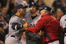 BOSTON, MA:  Carlos Pena #23 and Ben Zobrist #18 of the Tampa Bay Rays have words with pitching coach Bob McClure #22 of the Boston Red Sox after teammate Luke Scott was hit by a pitch in the ninth inning at Fenway Park  in Boston, Massachusetts. (Photo by Jim Rogash/Getty Images)
